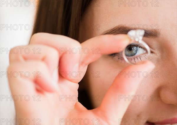 Young woman holding engagement ring