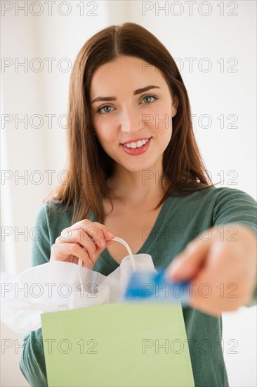 Young woman holding shopping bag and credit card