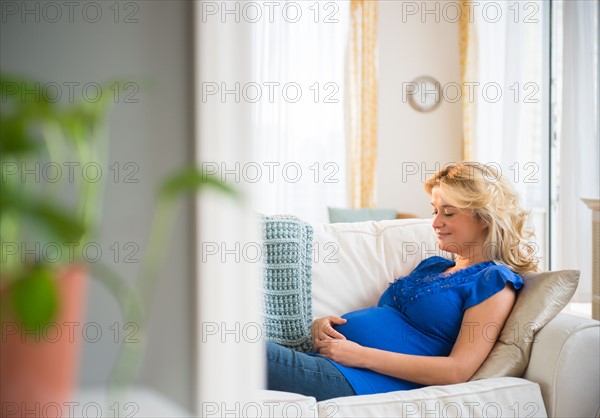 Pregnant woman sitting on sofa