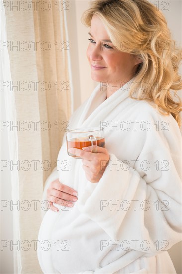 Pregnant woman holding tea cup