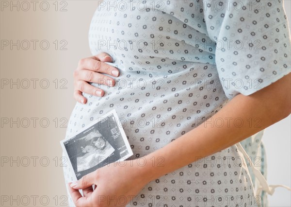 Pregnant woman with ultrasound scan of fetus