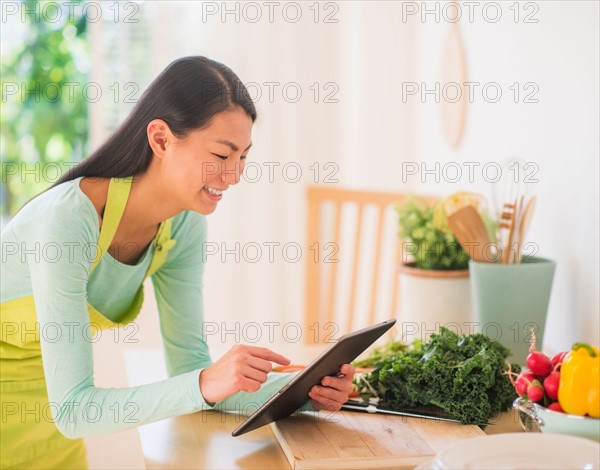 Teenage girl with bunch of vegetables in kitchen