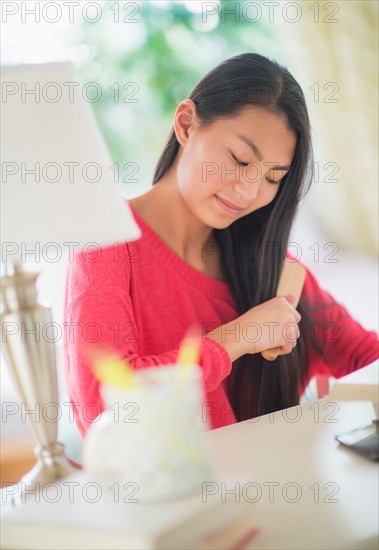 View of teenage girl ( 16-17 years) brushing hair