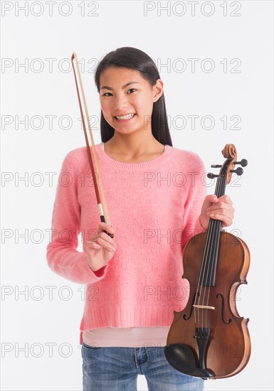 Portrait of teenage girl ( 16-17 years) holding violin