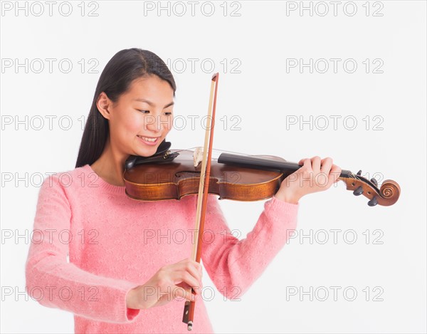 View of teenage girl ( 16-17 years) playing violin