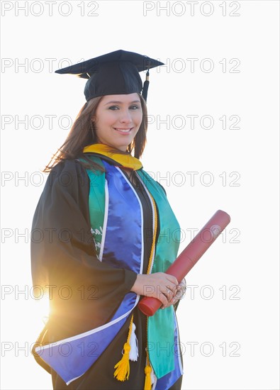 Portrait of graduate student holding diploma