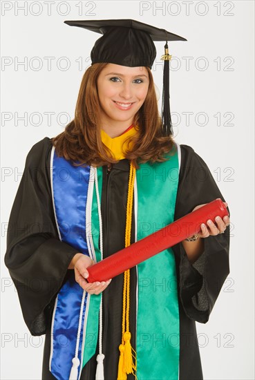 Portrait of graduate student holding diploma