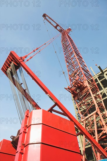 Low angle view of crane and building under construction