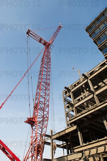 Low angle view of crane and building under construction