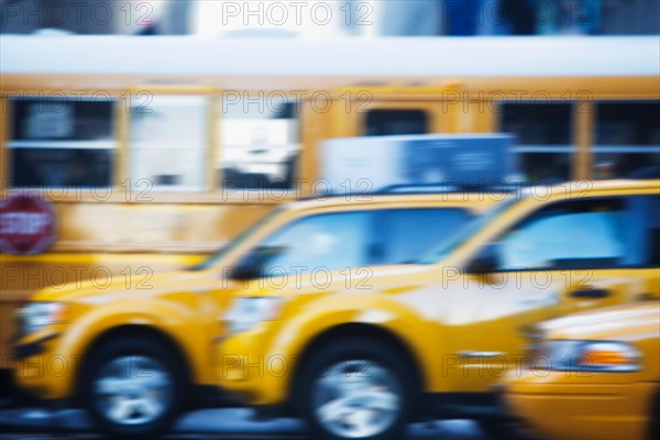 Taxicabs and yellow bus