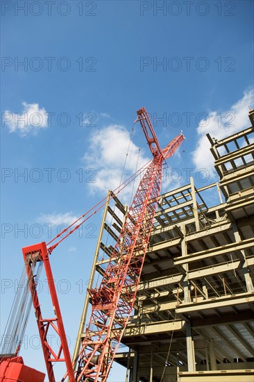 Low angle view of crane and building under construction