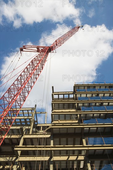 Low angle view of crane and building under construction