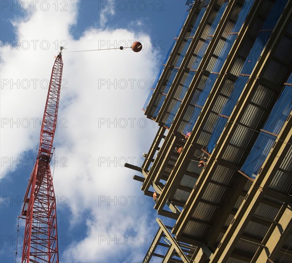 Low angle view of crane and building under construction