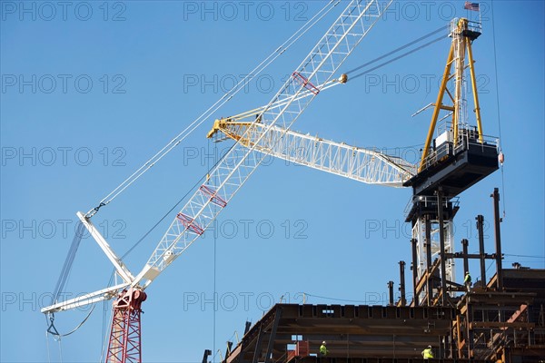 Low angle view of crane and construction frame