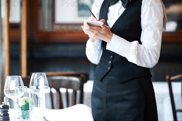 Young waitress taking order