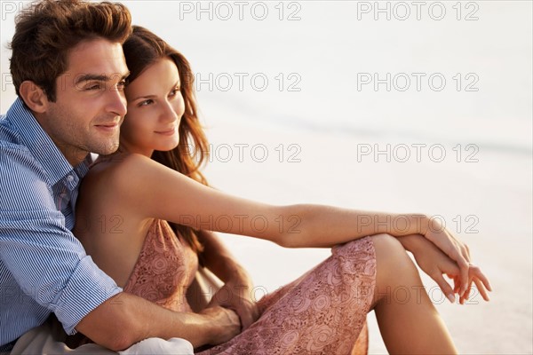 Portrait of couple hugging on beach