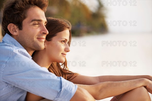 Portrait of couple hugging on beach