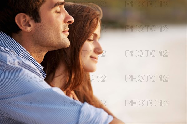 Portrait of couple hugging on beach