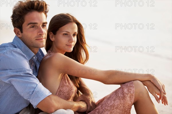 Portrait of couple hugging on beach