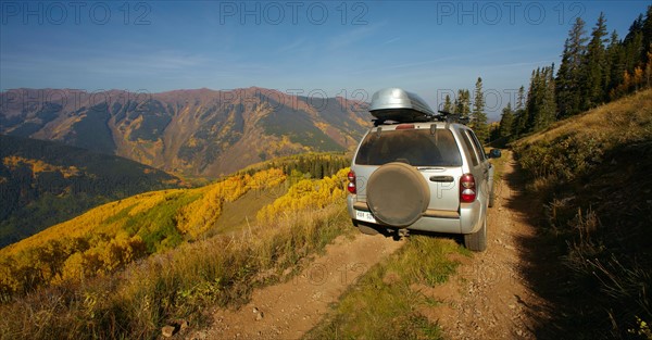 Mountain landscape with car on dirt road