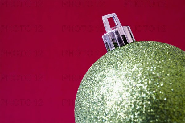 Close up of shiny Christmas decoration on red background