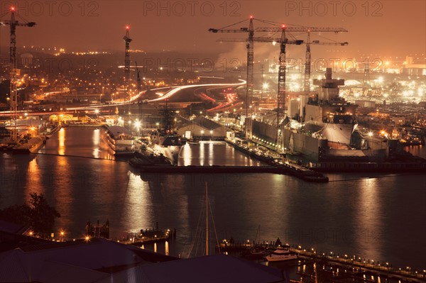 Cityscape with cranes at night