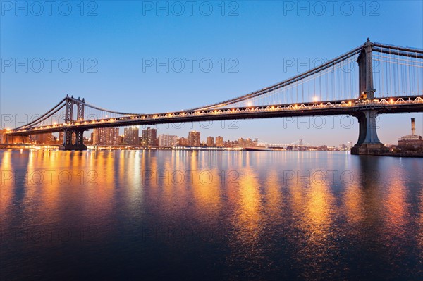Cityscape with bridge lights reflected in water