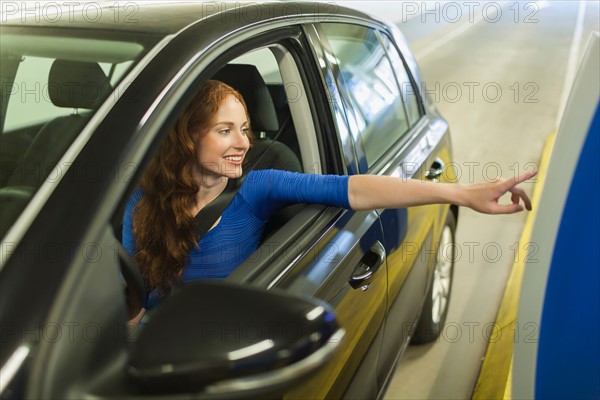 Young woman parking car