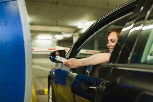 Young woman parking car