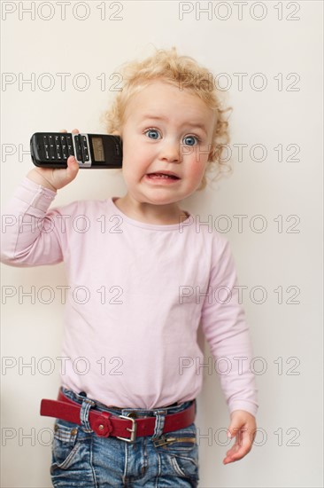 Studio shot of girl (2-3) using phone