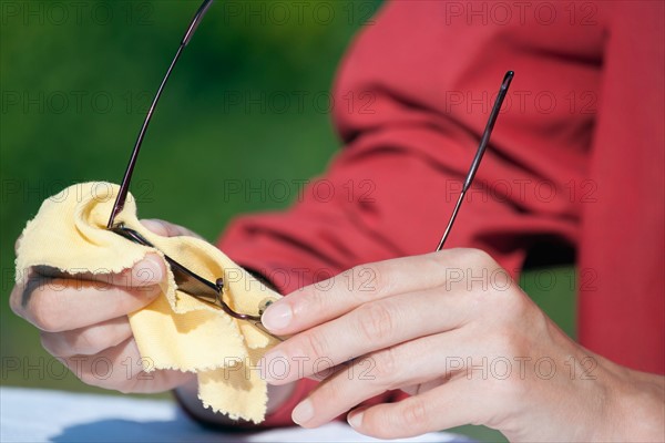 Woman cleaning sunglasses