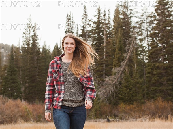 Portrait of young woman walking in non-urban scene