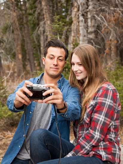 Young couple self photographing in non-urban scene