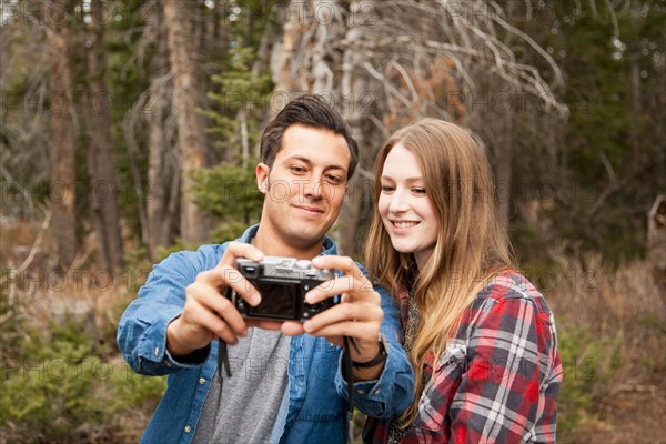 Young couple self photographing in non-urban scene