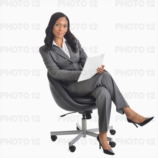 Portrait of businesswoman sitting in chair.