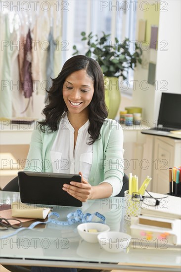 Female entrepreneur using digital tablet.