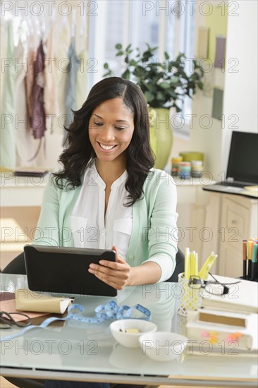 Female entrepreneur using digital tablet.