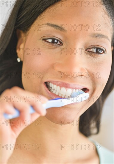 Woman brushing teeth.