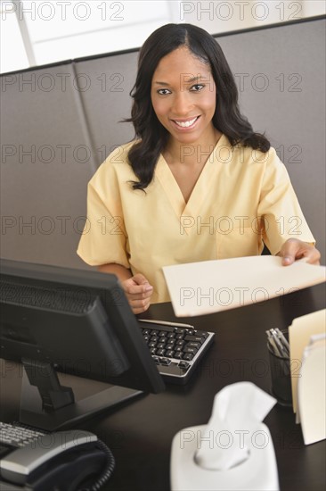 Portrait of female nurse at station.