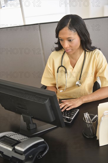 Portrait of female nurse at station.