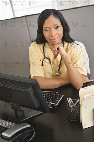 Portrait of female nurse at station.