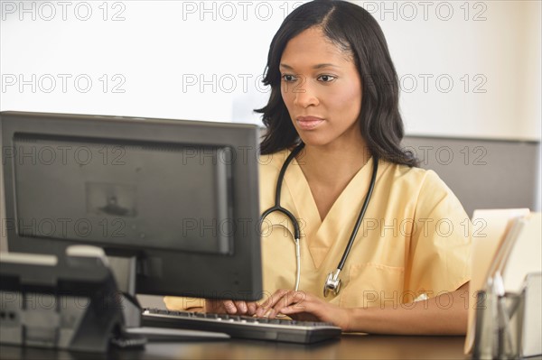 Female nurse at station.