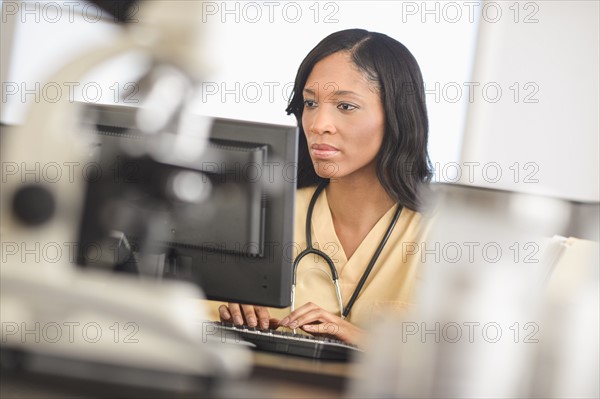 Female nurse at station.