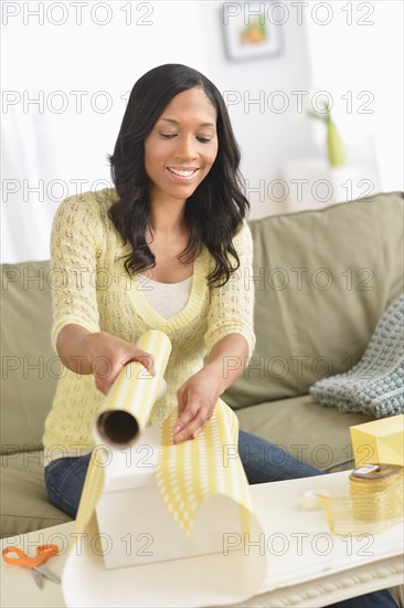 Woman wrapping presents.
