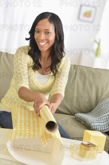Woman wrapping presents.