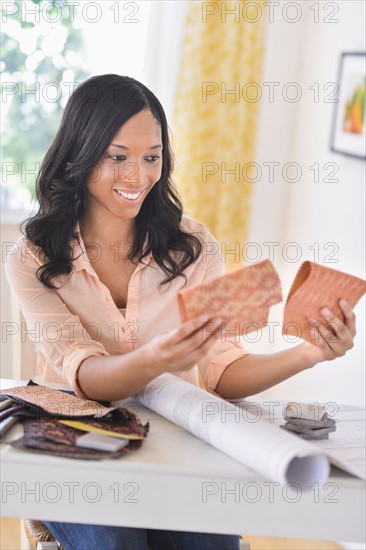 Woman choosing color swatches.