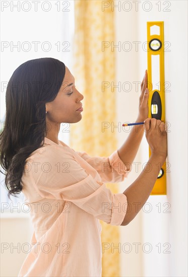 Woman using spirit level.