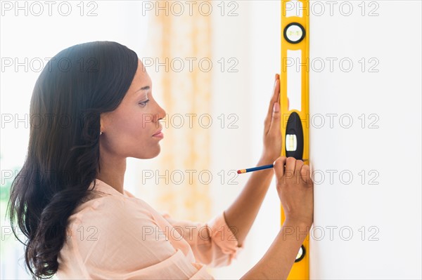 Woman using spirit level.