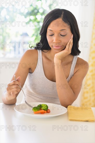 Woman eating vegetables.