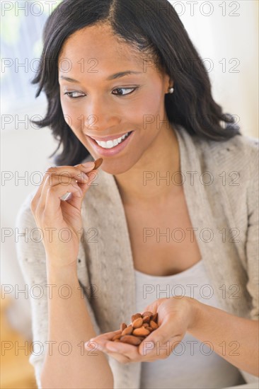 Woman eating almonds.